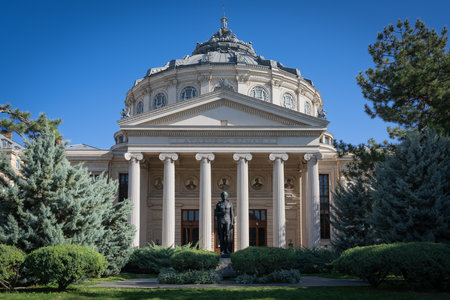 The Romanian Athenaeum in Bucharest, Romania, captured on a clear day. This neoclassical concert...
