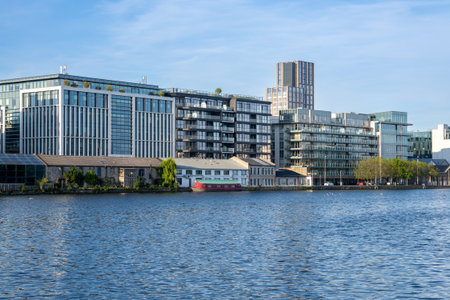 View of the Grand Canal Dock in Dublin, Ireland, with calm waters, a clear blue sky, and modern buildings in the background, showcasing the contemporary side of the city.の写真素材