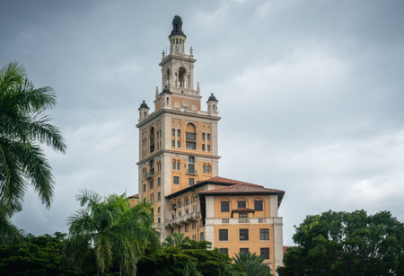The historic Biltmore Hotel in Coral Gables, Miami, captured on a cloudy day, showcasing its Mediterranean Revival architecture and iconic tower surrounded by lush greenery.の写真素材