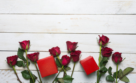 Rose and red gift box Placed on a vintage white wooden background.の写真素材