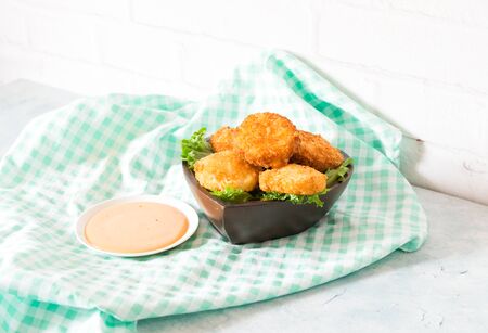 Shrimp fry is made from shrimp meat, mixed with fried dough until golden, crispy, appetizing. Served in a wooden cup, decorated with lettuce With thick sauce. Placed on a green checkered tablecloth.の写真素材