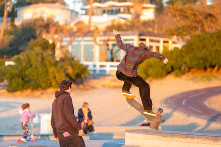 young man jumping on skateboard in a skateparkの写真素材