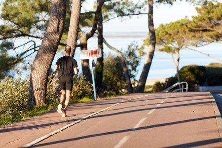 Young man running on the Promenade.の写真素材