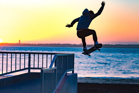 skateborder silhouette jumping in a skateparkの写真素材