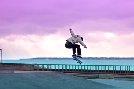 Skateboarder doing a trick in a skate parkの写真素材
