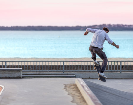 Skateboarder doing a trick in a skate parkの写真素材