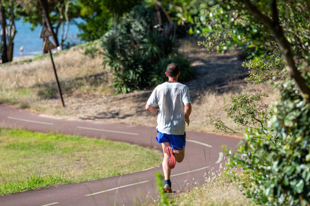 Young man running on the Promenade a sunny day
