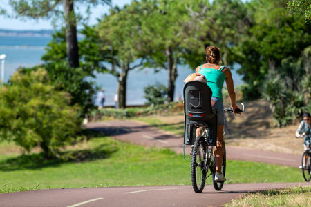 Person riding a bicycle on a cycle path on a sunny dayの写真素材