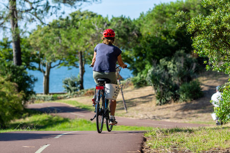 Person riding a bicycle on a cycle path on a sunny dayの写真素材