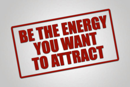 Be the energy you want to attract. A red stamp illustration isolated on light gray background.の写真素材