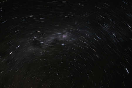 a long exposure of the dark sky with the stars and the milky way and a circumpolar nebulousの写真素材