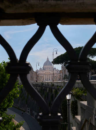 a different or alternative panoramic view between the bars of a fence of the Saint Peter church in Vatican Cityのeditorial素材