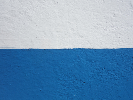 Wall background painted half blue and half white.
