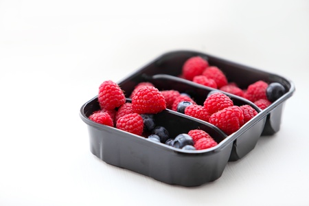Raspberry and blueberry in packing の写真素材