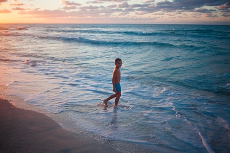 Boy on the beach,  evening seascape, Cubaのeditorial素材