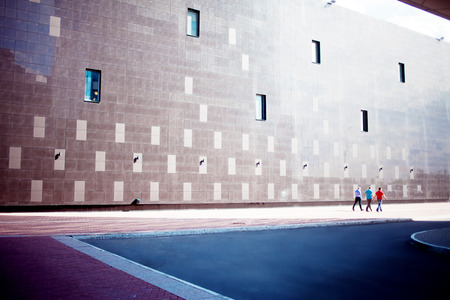 high-tech wall, three people goes awayの写真素材