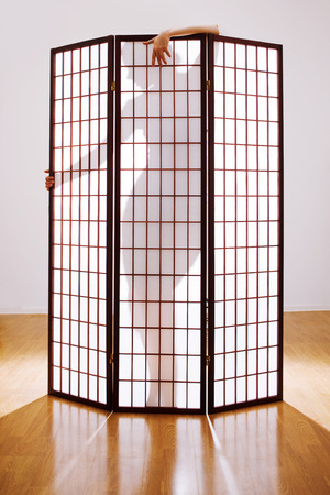 woman silhouette, behind a screenの写真素材