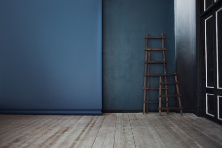 Two Wooden ladder, near dark blue wallの写真素材