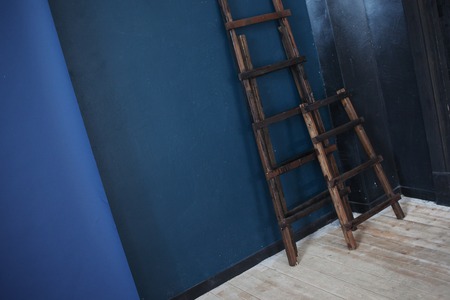 Two Wooden ladder, near dark blue wallの写真素材