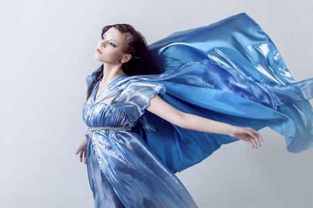 young magnificent woman in blue dress. Studio photoの写真素材