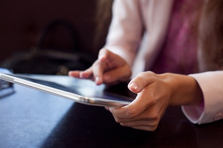 girl works on the digital tablet, a small depth of field