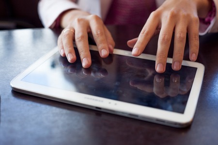 girl works on the digital tablet, a small depth of fieldの写真素材
