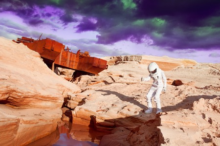 futuristic astronaut on another planet, sandy red planetの写真素材