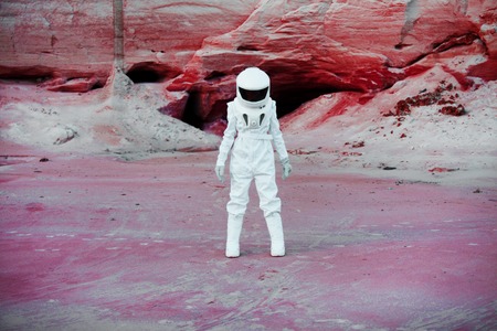 futuristic astronaut on another planet, sandy red planetの写真素材
