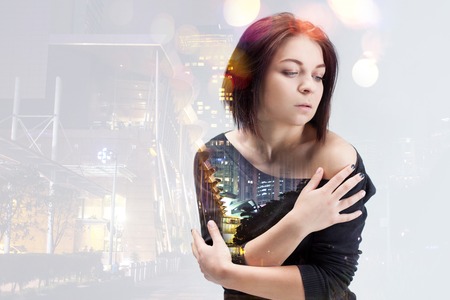 woman thinking about big city at night.
