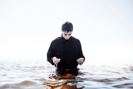 A young man experiencing the pain and disappointmentの写真素材