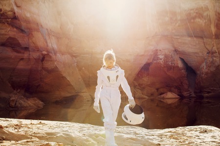 futuristic astronaut on another planet, sandy red planet