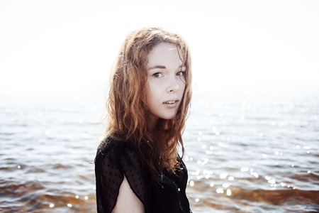 Young woman outdoors portrait. Soft sunny colors.の写真素材