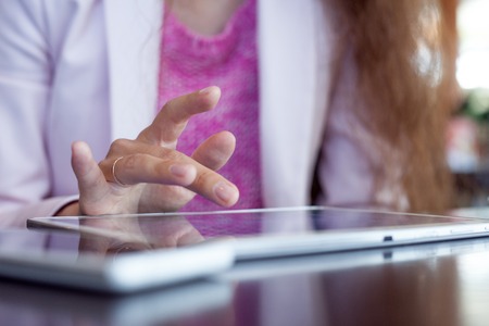 girl works on the digital tablet, a small depth of fieldの写真素材