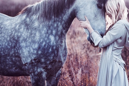 Portrait of a beauty blondie with horseの写真素材