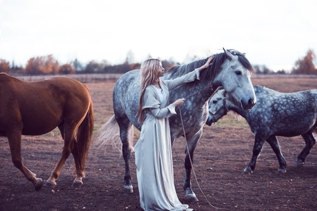 Portrait of a beauty blondie with horseの写真素材