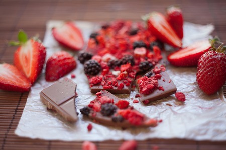 Handmade chocolate with fresh and dried berries, raspberries, strawberries, black currants, blackberries, cocoa powderの写真素材
