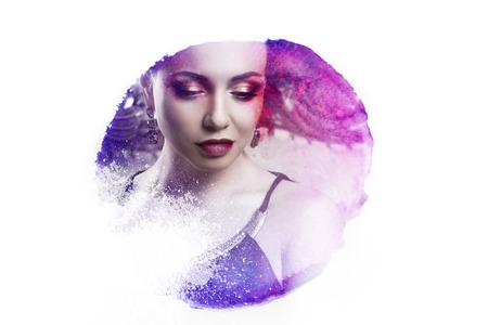 attractive young brunette sitting on a beautiful sofa, portrait close-up, gold eyeshadowの写真素材