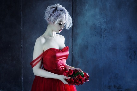Fashion photo of young magnificent woman in red dress.の写真素材