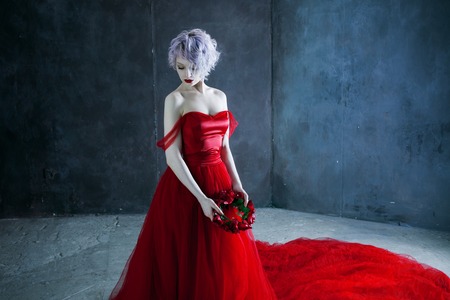 Fashion photo of young magnificent woman in red dress.の写真素材