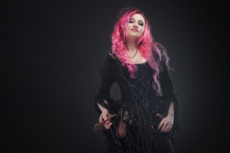 Attractive woman with red hair in witches costume
