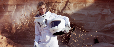 futuristic astronaut on another planet, sandy red planetの写真素材