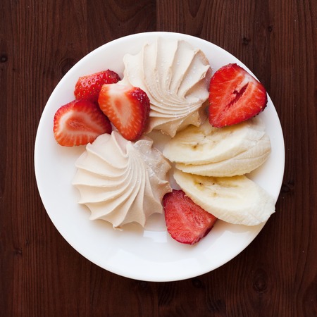 fresh strawberries and marshmallows on rustic wooden background.の写真素材