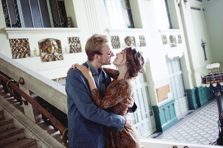 Man hugs a woman. The girl looks over the shoulder of a partnerの写真素材