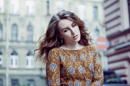 Portrait of young beautiful girl walking on the city center