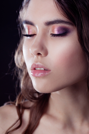 close-up face, bright eye shadow, makeup. Shallow depth of field.の写真素材