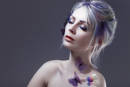 Beautiful Girl With Butterfly. Creative Make up and Hair Style.の写真素材