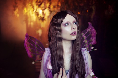Young beautiful woman in the image of fairies, dark forestの写真素材
