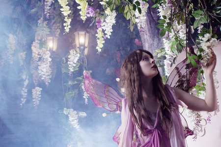 Young beautiful woman in the image of fairies, dark forestの写真素材