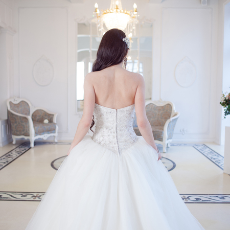 Portrait of beautiful bride. Wedding dress with open back. Wedding decorationの写真素材