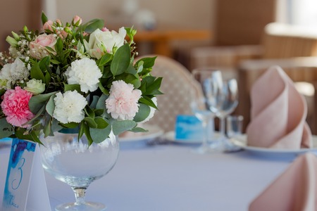 Wedding floristry. Beautiful lush bouquet on the table in the restaurant